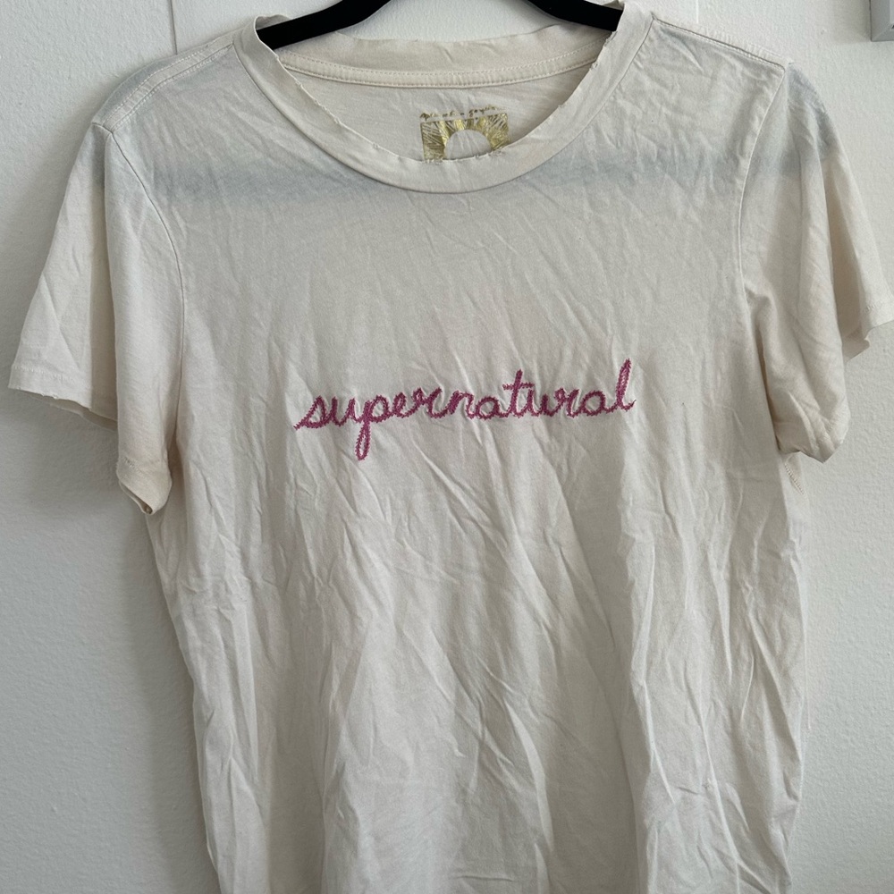 White “supernatural” tee
